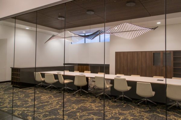 Conference room in Salt Lake City Utah Data Center with a long table and unique twisting chandelier | Novva Data Centers