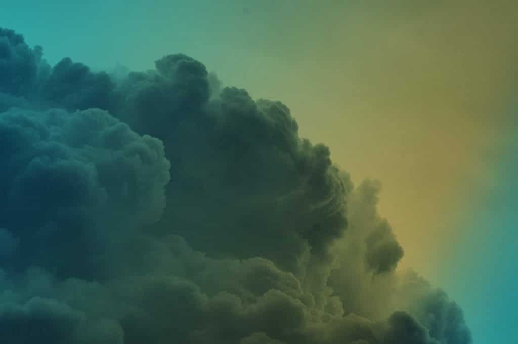 Fluffy white clouds with a blue to yellow gradient overlay