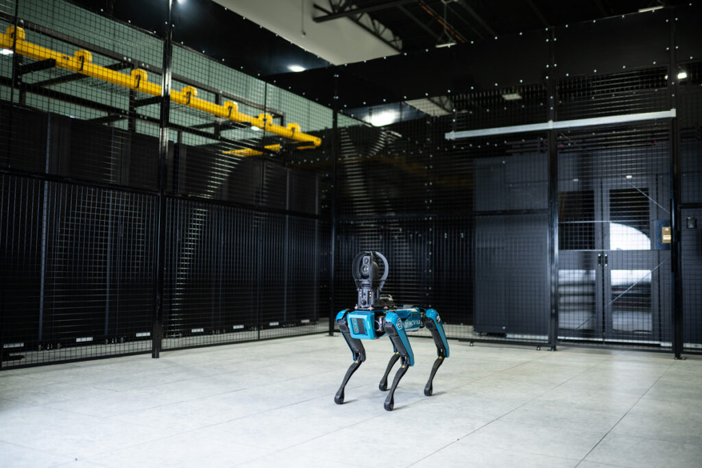 WIRE - Novva Data Centers robotic security dog standing in front of data center security gate in Salt Lake City, Utah