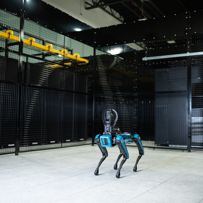 WIRE - Novva Data Centers robotic security dog standing in front of data center security gate in Salt Lake City, Utah